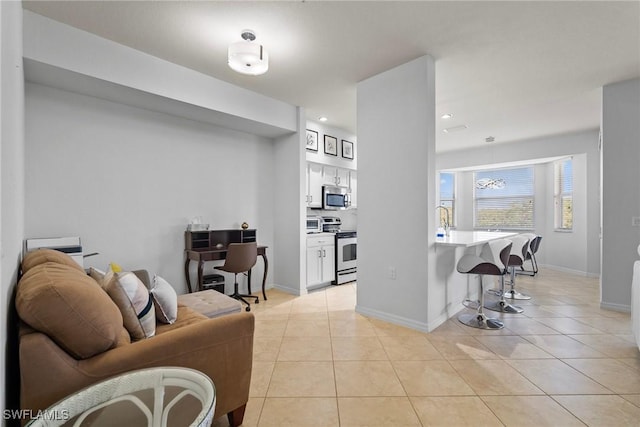 living room featuring light tile patterned floors, baseboards, and recessed lighting