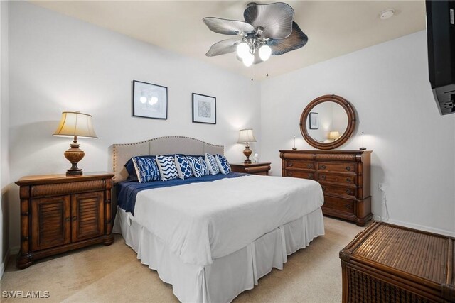 bedroom featuring light carpet and ceiling fan