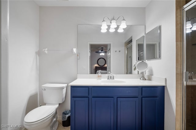 bathroom with vanity, a shower with door, and toilet