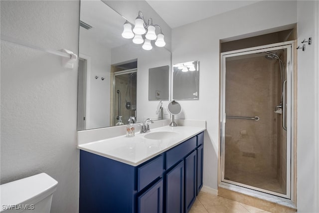 bathroom with vanity, an enclosed shower, toilet, and tile patterned floors