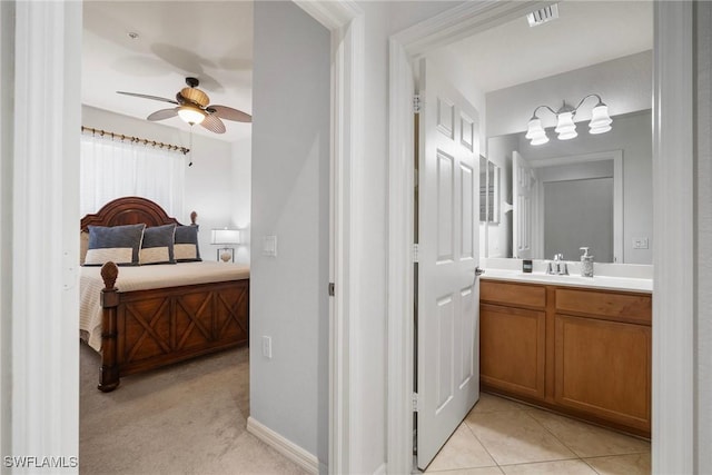 bathroom with visible vents, ceiling fan, vanity, ensuite bath, and tile patterned floors