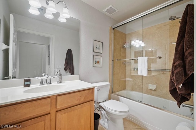 full bathroom with toilet, vanity, visible vents, combined bath / shower with glass door, and tile patterned floors