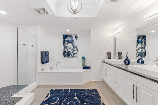 bathroom featuring vanity, independent shower and bath, and ornamental molding