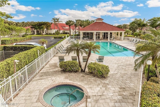 view of swimming pool featuring a community hot tub