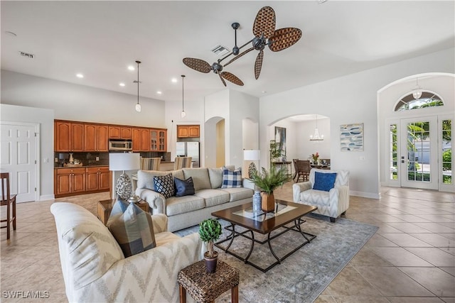 tiled living room featuring a high ceiling and ceiling fan