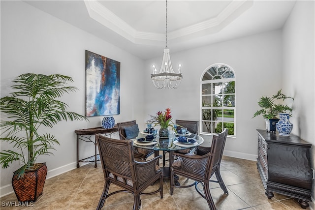 dining area featuring crown molding, light tile patterned flooring, a chandelier, and a raised ceiling