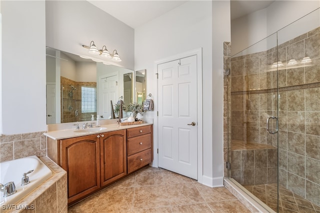 bathroom with shower with separate bathtub, tile patterned flooring, and vanity