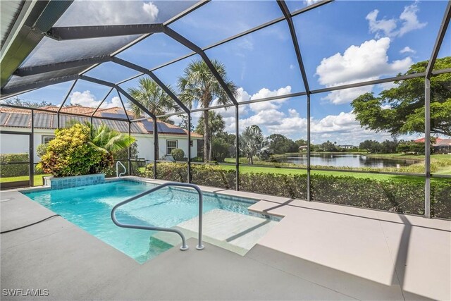 view of swimming pool with a lanai, a water view, and a patio area