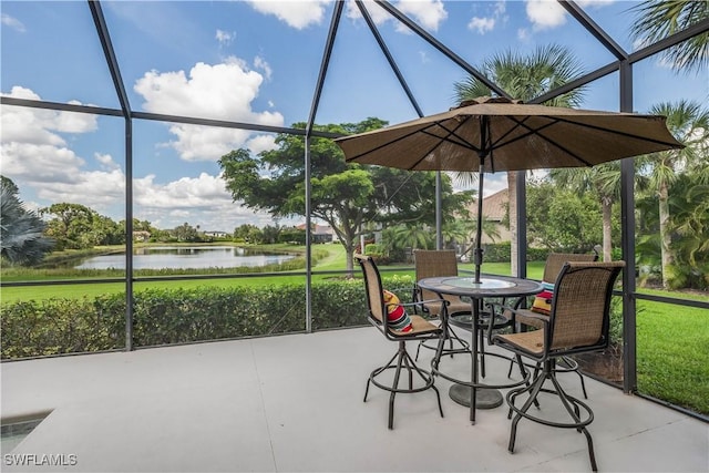 sunroom / solarium featuring a water view