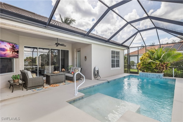 view of pool with ceiling fan, outdoor lounge area, glass enclosure, and a patio