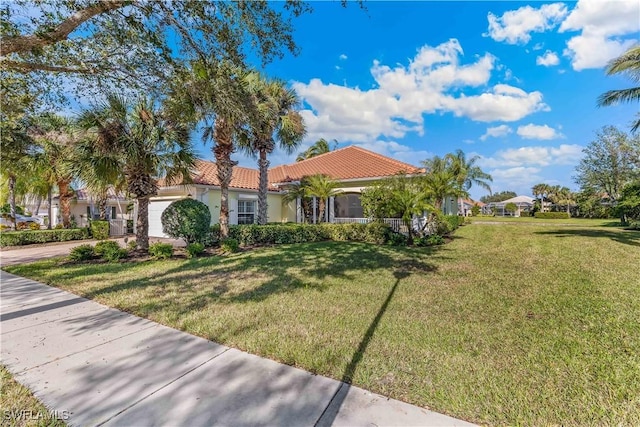 mediterranean / spanish house with a front yard