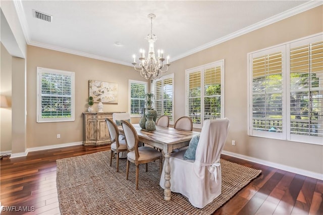 dining space featuring crown molding, dark hardwood / wood-style floors, and a notable chandelier