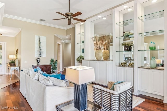 living room with ornamental molding, ceiling fan, and dark wood-type flooring