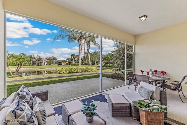 sunroom featuring a water view and a healthy amount of sunlight