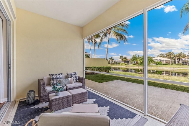 sunroom / solarium with a water view and a healthy amount of sunlight