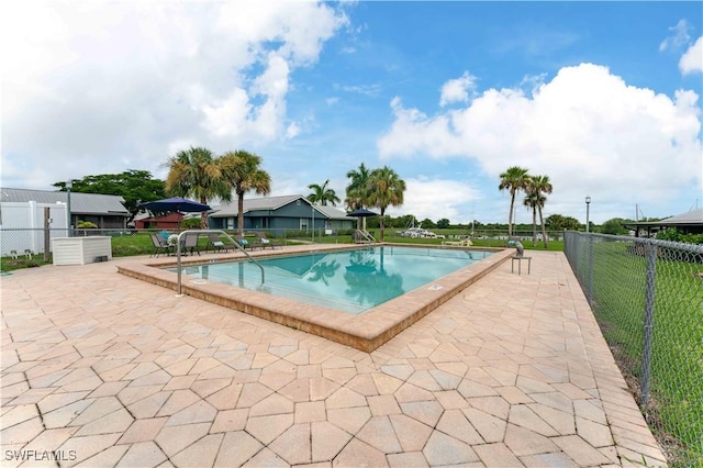 community pool featuring a patio area and fence