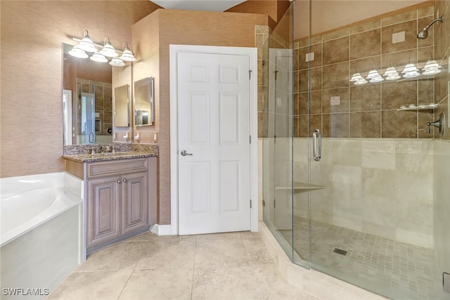 bathroom with a bath, tile patterned floors, a stall shower, and vanity