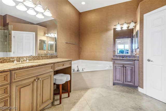 bathroom featuring a sink, a garden tub, two vanities, and tile patterned flooring