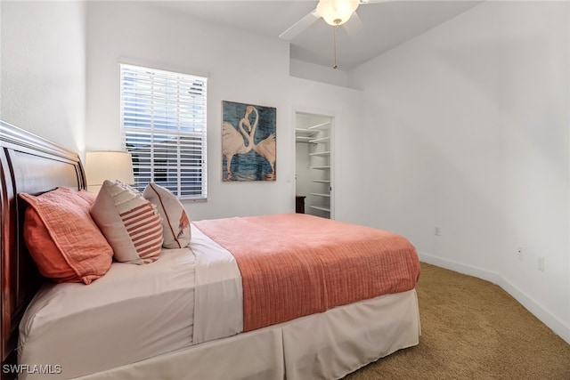 bedroom featuring baseboards, carpet floors, ceiling fan, and a spacious closet