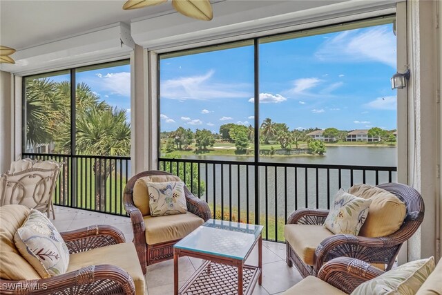 sunroom / solarium with a water view and a healthy amount of sunlight