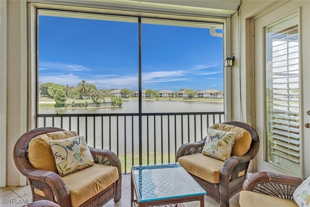 sunroom with a healthy amount of sunlight and a water view