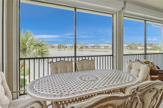 sunroom / solarium with a water view