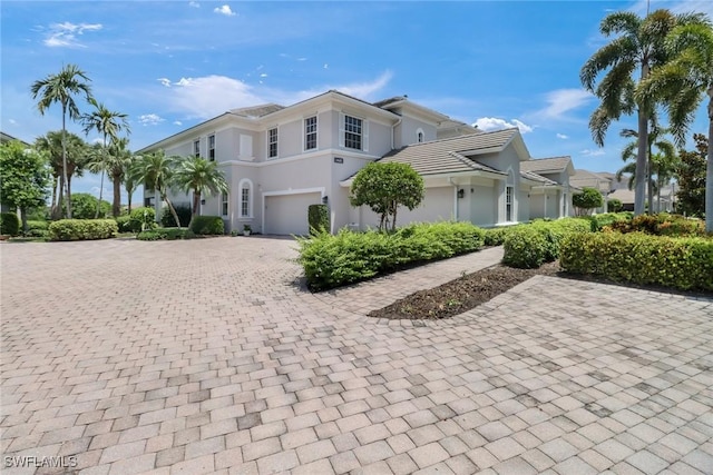 exterior space with decorative driveway and stucco siding