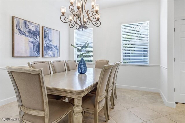 tiled dining area featuring a healthy amount of sunlight and a notable chandelier