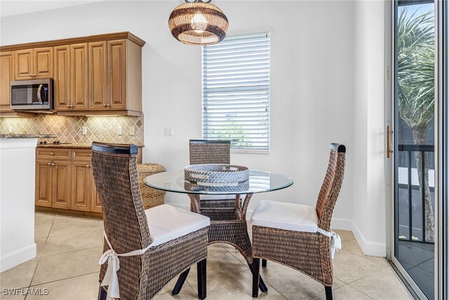 dining area featuring light tile patterned flooring