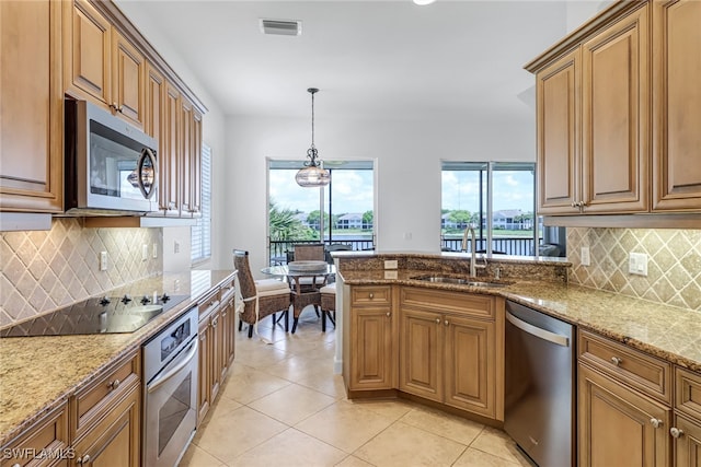 kitchen featuring light stone counters, light tile patterned floors, visible vents, a sink, and stainless steel appliances