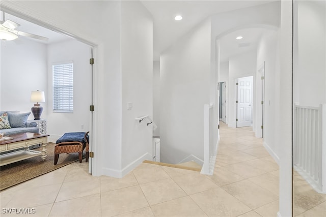 corridor featuring recessed lighting, baseboards, an upstairs landing, and light tile patterned flooring