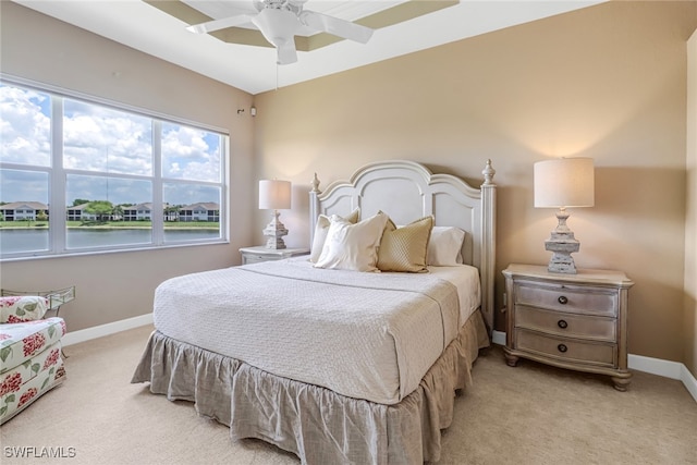 carpeted bedroom with ceiling fan and baseboards