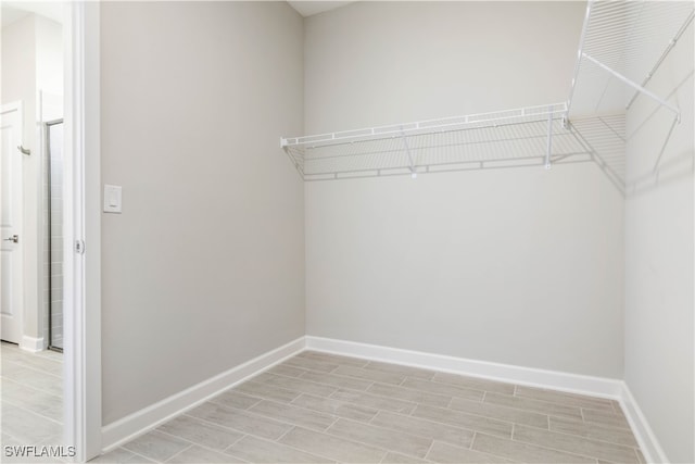 walk in closet featuring light hardwood / wood-style flooring