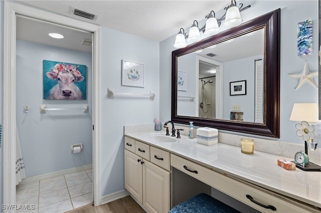 bathroom with tile patterned floors and vanity