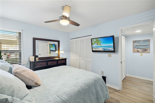 bedroom featuring ceiling fan, light hardwood / wood-style flooring, and a closet