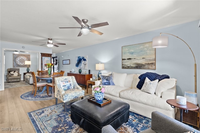 living room with ceiling fan and wood-type flooring