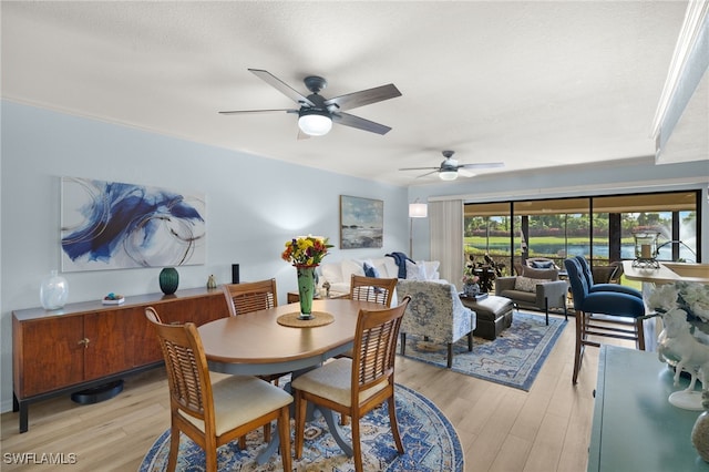 dining room with light hardwood / wood-style flooring and ceiling fan