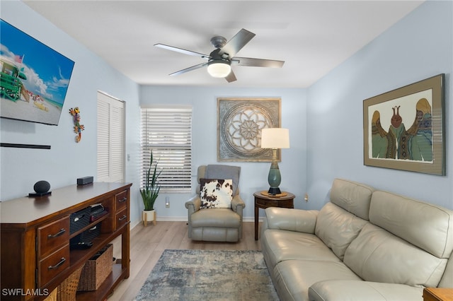 living room featuring ceiling fan and light hardwood / wood-style floors