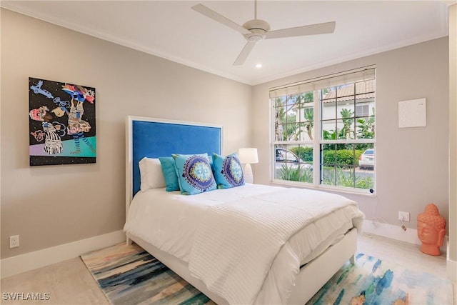 bedroom featuring ornamental molding, a ceiling fan, and baseboards