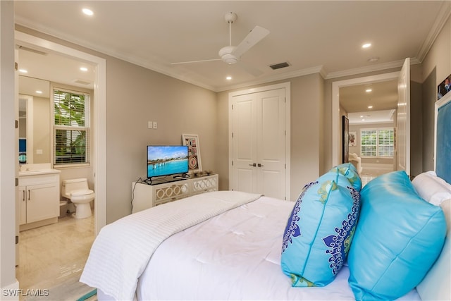 bedroom featuring ceiling fan, ornamental molding, a closet, and ensuite bathroom