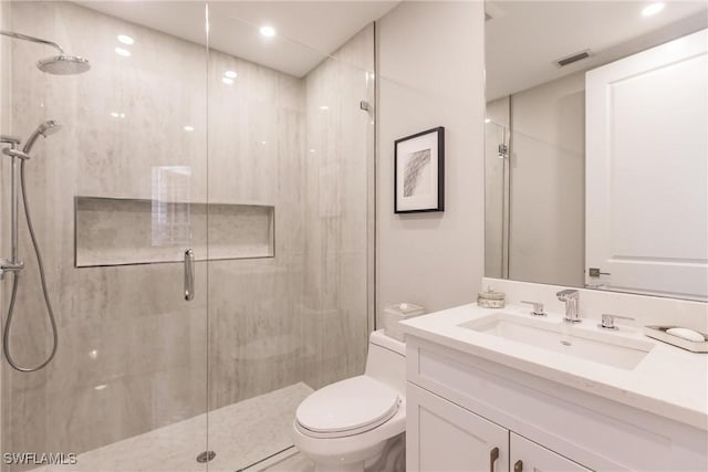 bathroom featuring toilet, vanity, a marble finish shower, and visible vents