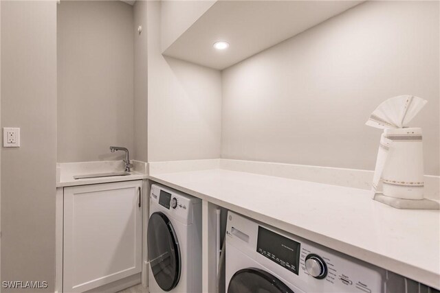 laundry room featuring washer and dryer and sink