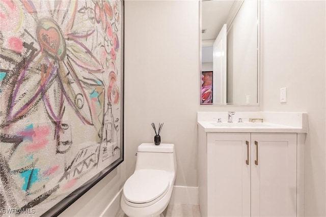 bathroom featuring toilet and vanity