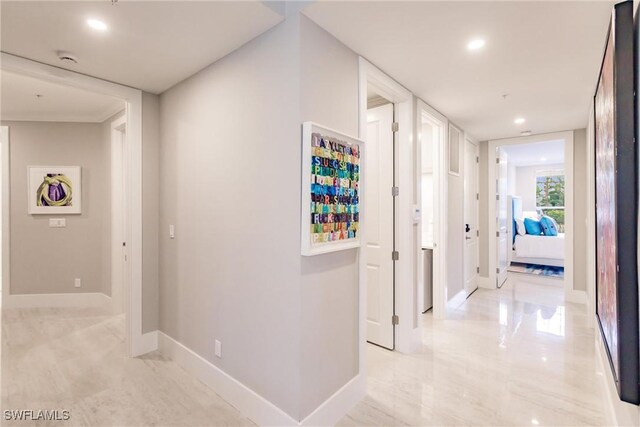 hall with recessed lighting and baseboards