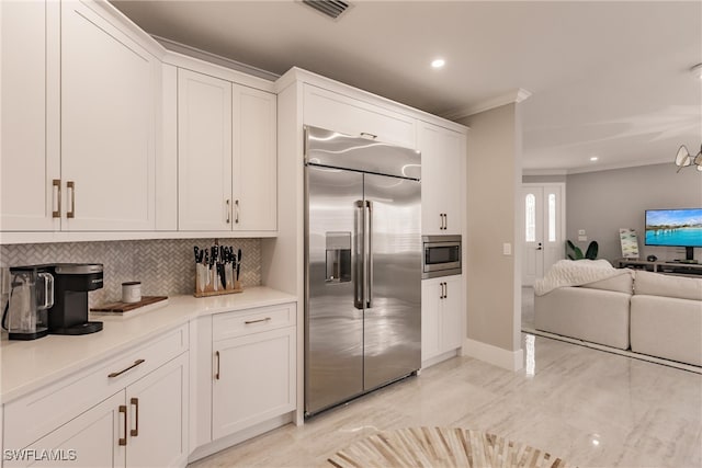 kitchen with built in appliances, visible vents, open floor plan, ornamental molding, and tasteful backsplash