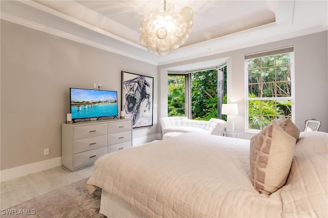 bedroom with a tray ceiling, a chandelier, and ornamental molding