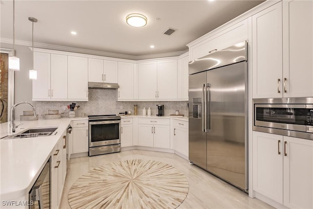 kitchen featuring visible vents, decorative backsplash, a sink, built in appliances, and under cabinet range hood