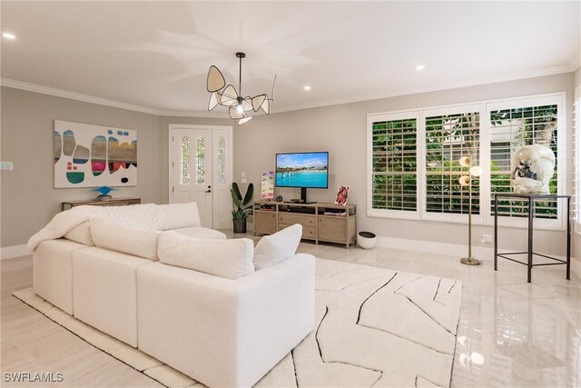 living room with crown molding, a chandelier, and light hardwood / wood-style flooring