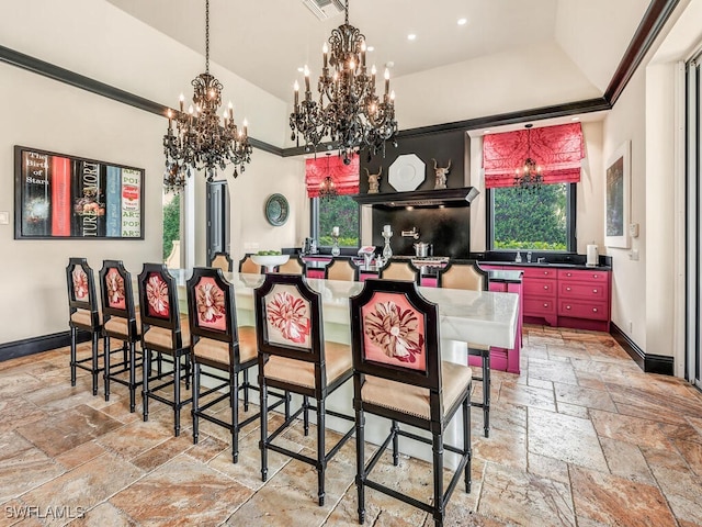 dining space with a healthy amount of sunlight, sink, and a notable chandelier