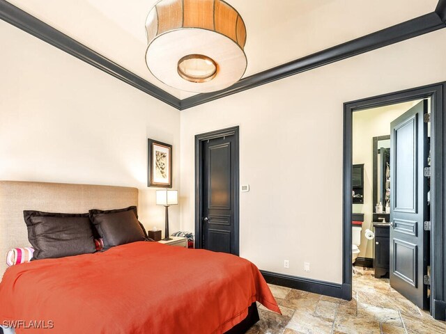 bedroom featuring crown molding and connected bathroom